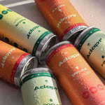 Load image into Gallery viewer, adapt focus and relax cans standing side-by-side, with water droplets on